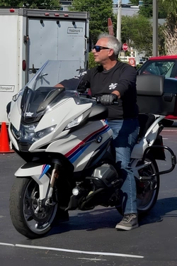Mark Turkel on his white BMW motorcycle